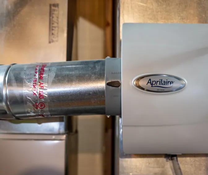 An Aprilaire whole-home humidifier mounted on a home&rsquo;s ductwork